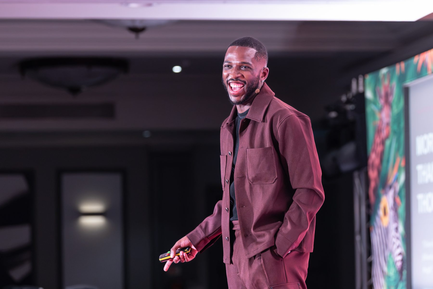 Washington Ali laughing on stage mid-talk